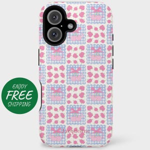 May include: A white phone case with a pink and blue checkered pattern featuring cherries and bows. The case has a cutout for the camera lens and the text "Jacqueline" is printed on the bottom.