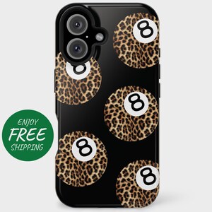 May include: Black phone case with a leopard print pattern and white 8-ball designs.