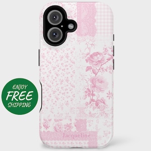 May include: A pink and white floral phone case with a camera cutout and the word "Jacqueline" printed on the bottom.