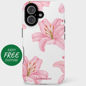 May include: White phone case with a pink watercolor lily flower design. The case has a clear back and a white border. The text "Jacqueline" is printed on the bottom of the case.