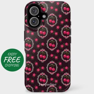 May include: A black phone case with a repeating pattern of red cherries in white oval frames with pink bows and flowers. The text "Jacqueline" is at the bottom. A green circle with the text "ENJOY FREE SHIPPING" is on the left.