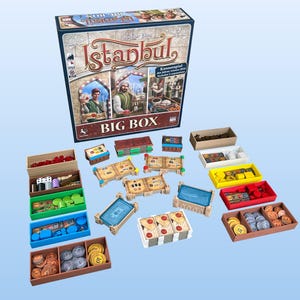 May include: Istanbul board game big box edition with colorful game pieces and storage compartments. The box features a colorful illustration of the game's theme.