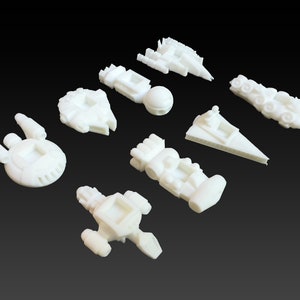 May include: A collection of nine white 3D printed miniature spaceships. The spaceships are all different shapes and sizes, and some have details like windows and engines.