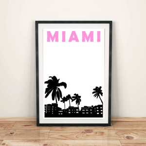 May include: A black and white print of palm trees and buildings with the word "MIAMI" in pink letters.
