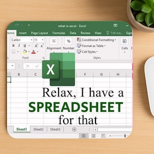 May include: A green mouse mat featuring an Excel spreadsheet interface. The text "Relax, I have a SPREADSHEET for that" is displayed. A white mouse, keyboard, and a small potted plant are also visible on a wooden surface.