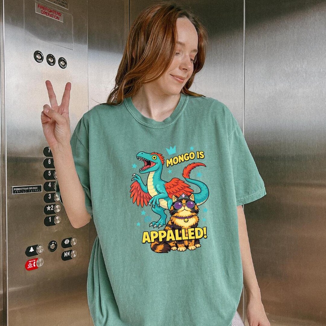 Giant Princess Riding Mongo Retro Mongo is Appalled Princess Cat Riding Dinosaur Comfort Colors© T ...