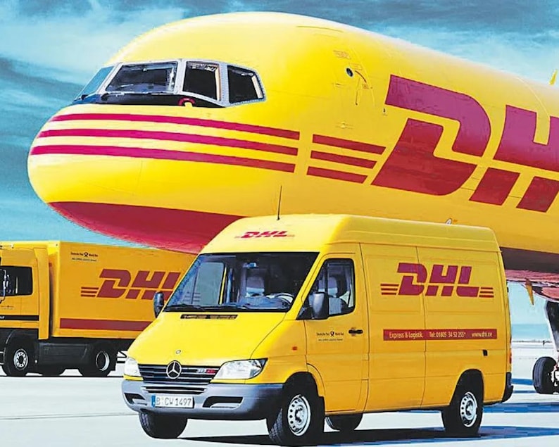May include: A yellow DHL delivery van and truck are parked in front of a yellow and red airplane. The DHL logo is prominently displayed on the vehicles and the plane. The sky is blue.