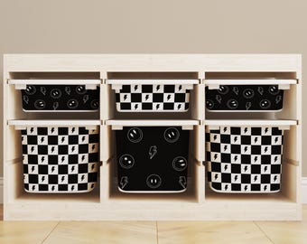 May include: Six black and white storage bins with different patterns. The patterns include a checkered pattern, a smiley face pattern, and a lightning bolt pattern.