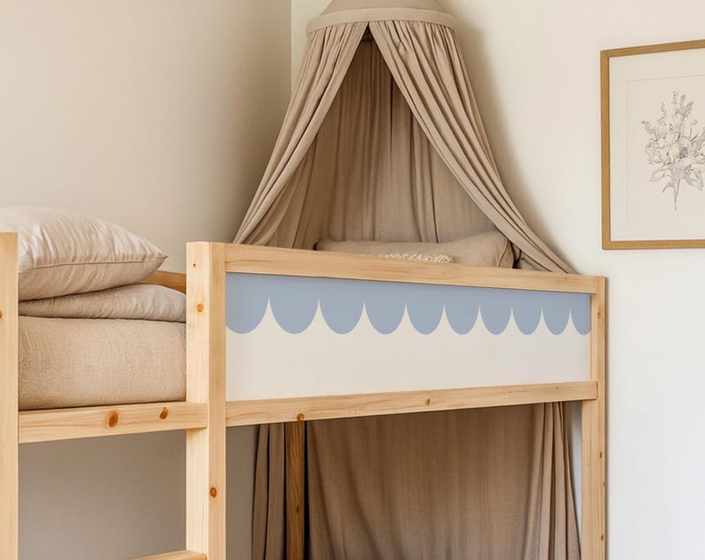 May include: A light wood bunk bed with a blue scalloped design on the headboard. The bed is adorned with beige bedding and a matching canopy. A framed botanical print hangs on the wall.