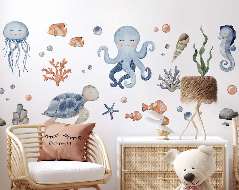 May include: A set of blue and orange watercolor ocean animal wall decals. The decals include a jellyfish, octopus, sea turtle, starfish, seahorse, and coral.