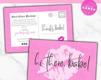May include: Pink thank you card template with a pink lip print and the text "hi there, babe!"  The back of the card has a space for a business name, social media handle, and website. The text "First Class Postage" is at the top of the card.
