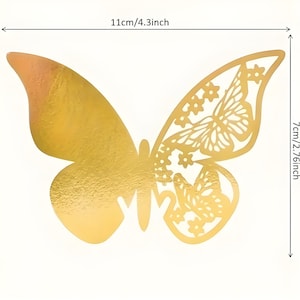 May include: A gold-colored butterfly decoration with intricate cut-out details on one wing. The butterfly measures 4.3 inches wide and 2.76 inches high. The other wing is solid gold. Perfect for crafts, scrapbooking, or party decorations.