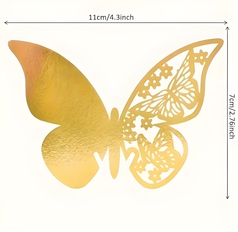 May include: A gold-colored butterfly decoration with intricate cut-out details on one wing. The butterfly measures 4.3 inches wide and 2.76 inches high. The other wing is solid gold. Perfect for crafts, scrapbooking, or party decorations.