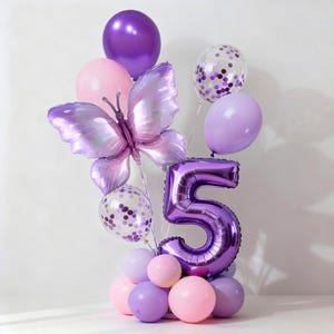 May include: A balloon bouquet featuring a large purple foil butterfly, a metallic purple number five balloon, and various round balloons in shades of light pink, lavender, and purple, including two clear balloons filled with purple confetti pieces.