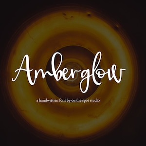 May include: A handwritten font called "Amberglow" displayed on a yellow and brown background. The text below the font says "a handwritten font by on the spot studio".