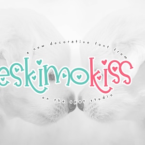 May include: A new decorative font called "Eskimo Kiss" from On The Spot Studio. The font is displayed in a teal and pink color scheme with small hearts.