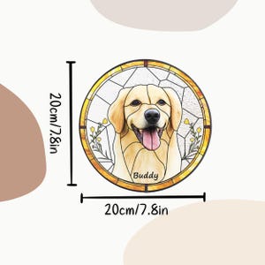May include: A round, stained-glass style decoration featuring a smiling golden retriever dog with the name "Buddy". The artwork is 7.8 inches in diameter and is framed with a gold border. The background is white with floral accents.
