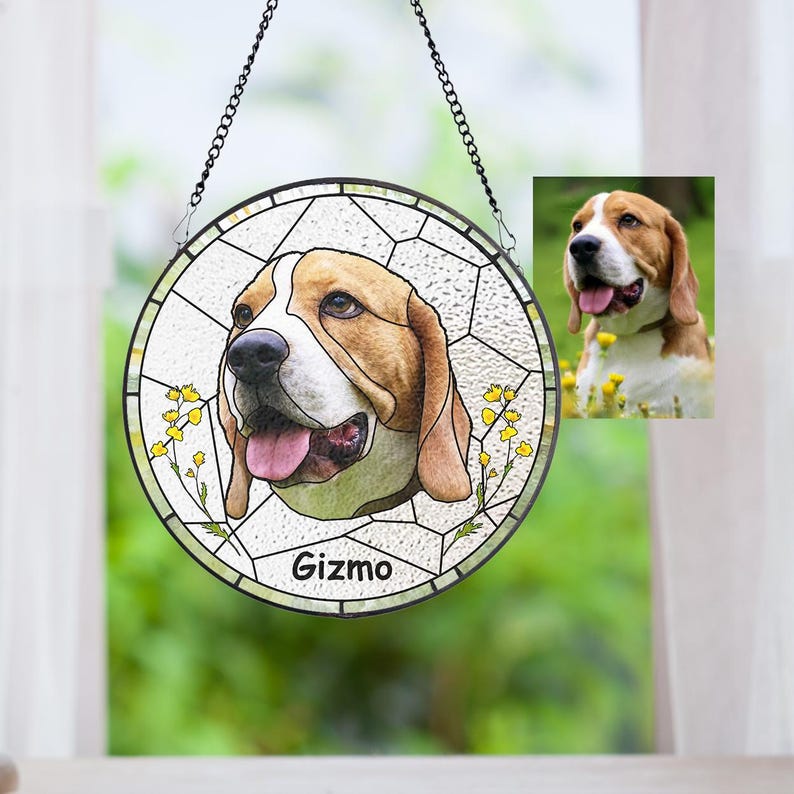 May include: A round stained glass window hanging featuring a beagle dog portrait with the name "Gizmo" at the bottom. The dog is brown, white, and tan with a pink tongue. The window is surrounded by a black metal frame and chain.