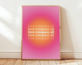 May include: A framed print with a pink and orange gradient background. The text "love conquers all" is repeated five times in white.