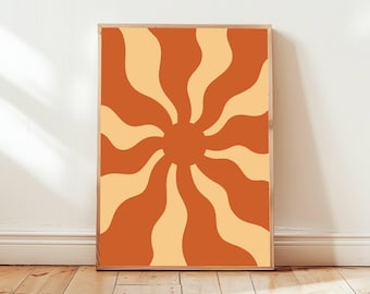 May include: A framed print with a retro sun design. The sun is made up of orange and yellow wavy lines radiating outward from a central orange circle.