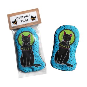 May include: A blue and green catnip toy shaped like a cat wearing a space helmet. The toy has a brown tag that says "Catnip Toy".