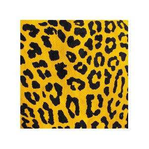 May include: Yellow fabric with a black leopard print pattern.