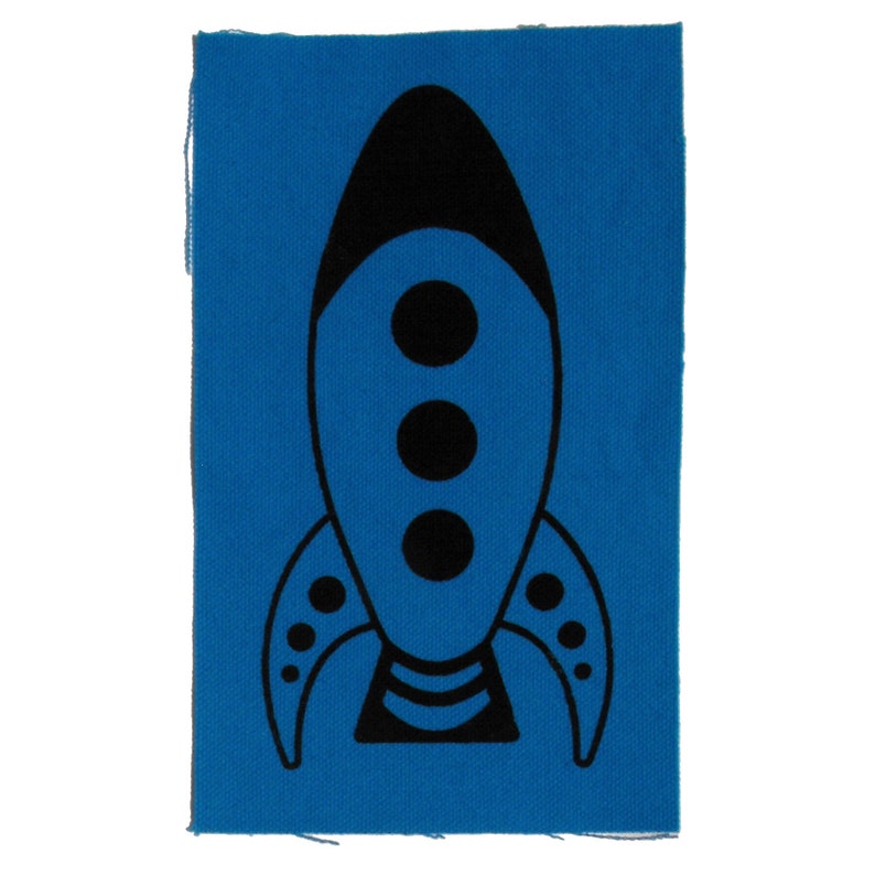 May include: A black rocket ship with three round windows on a blue fabric patch.