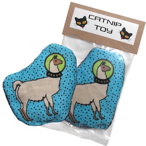 May include: Two blue and white catnip toys shaped like llamas wearing astronaut helmets. The toys have a black and white star pattern and the text "CATNIP TOY" is printed on the packaging.