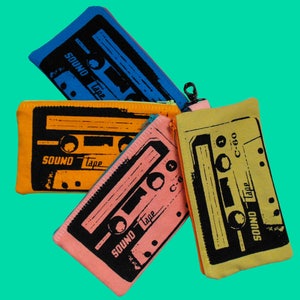 May include: Four colorful fabric pouches with a cassette tape design. The pouches are in shades of blue, orange, pink, and yellow. The text on the pouches reads "SOUND Tape" and "C-60".