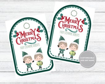 May include: Two printable gift tags featuring a green and white design with two elves holding gifts. The tags say "Merry Christmas" in red and "From Stephanie Roberts".