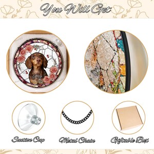 May include: A stained glass style round ornament featuring a brown and tan dachshund dog with pink roses and green leaves. The ornament comes with a metal chain, a suction cup, and a gift box.