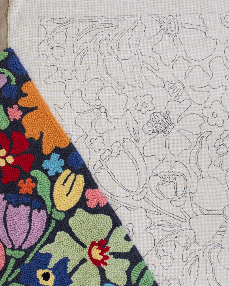 May include: A colorful, floral rug with a dark blue background and a variety of bright colors, including red, orange, yellow, and purple. Next to it is a canvas with a floral outline design.