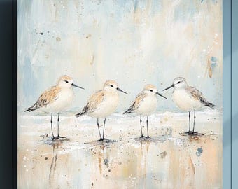 May include: Square canvas art featuring four shorebirds standing on a sandy beach. The birds have tan and gray feathers, with long black beaks and legs. The background is a soft blend of blue, beige, and white, creating a serene coastal scene.