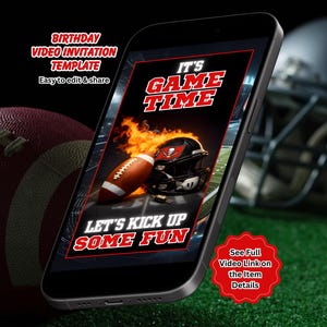 May include: A smartphone displays a football-themed birthday video invitation template. The screen shows a football, helmet, and flames with the text "IT'S GAME TIME" and "LET'S KICK UP SOME FUN". A football and helmet are in the background.
