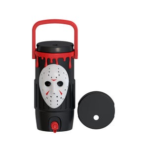 May include: A black cylindrical beverage dispenser with a red handle and a red spigot at the base. The exterior features a white hockey-style mask with red accents and a red drip pattern at the top. A separate black circular lid is placed to the right.