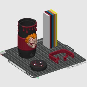 May include: A black cylindrical tumbler with red drip accents and a 3D relief of a scarred character face. Includes a matching black lid with a graphic of a face, a red U-shaped handle component, and a vertical stack of colored rectangular blocks.