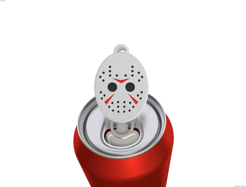 May include: A red aluminum beverage can featuring a white plastic tab cover shaped like a hockey mask. The mask is white with black dots, two black circular eye holes, and two red triangular markings above the eyes, attached to the can tab.