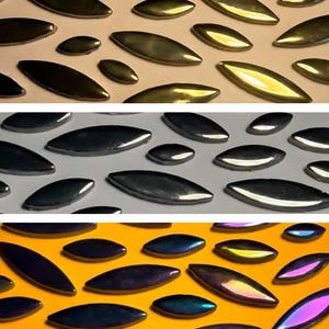 May include: Three rows of iridescent, oval-shaped tiles. The top row is gold, the middle row is silver, and the bottom row is a mix of purple, blue, and green.