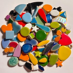 May include: A collection of colorful mosaic tiles in various shapes, including hearts, stars, and geometric forms. The tiles are in shades of blue, green, orange, red, and yellow. Some tiles have a glossy finish, while others appear matte.