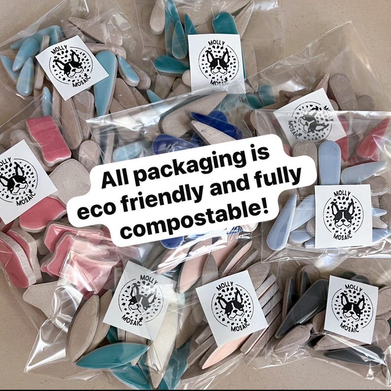 May include: Mosaic tiles in shades of blue, pink, and beige are packaged in clear bags. Each bag features a sticker with a dog logo and the text "MOLLY MOSAIC". The text "All packaging is eco friendly and fully compostable!" is also visible.