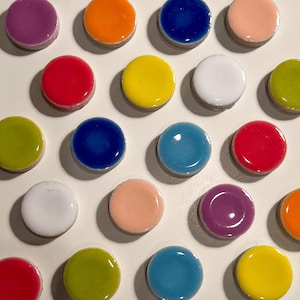 May include: Assortment of 16 colorful round ceramic tiles in various colors, including red, blue, yellow, green, purple, and white.