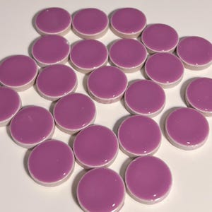 May include: A collection of 18 round ceramic tiles in a deep purple color. The tiles are arranged in a staggered pattern on a white surface.
