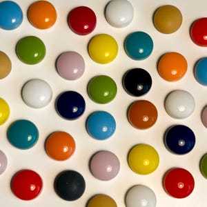 May include: Assortment of colorful round glass tiles in various colors, including red, blue, green, yellow, orange, white, black, and brown.