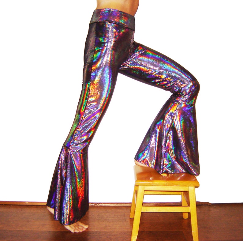 These pants are made from stretch velvet that has a holographic sheen on it. They are super sparkly, and comfortable to wear. They feature an extra wide flare and a wide band at the waist. They fit both men and women.
