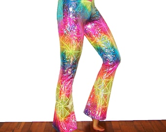 May include: Rainbow-colored, flared pants with a geometric pattern. The pants feature a vibrant spectrum of colors, including pink, yellow, green, and blue. The fabric has a shiny, sequined appearance. The pants are designed with a high waist and a flared leg opening.