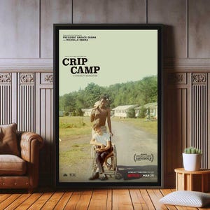 May include: A movie poster for the documentary "CRIP CAMP: A Disability Revolution" featuring a black and white photograph of two people, one in a wheelchair and one standing. The poster is black framed and has the text "PRESIDENT BARACK OBAMA and MICHELLE OBAMA" at the top. The poster also includes the text "sundance" and "IN SELECT CINEMAS AND ON NETFLIX MAR 25".