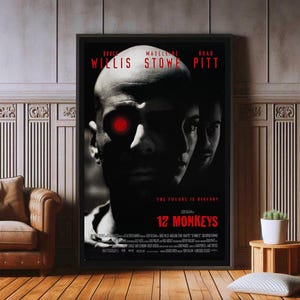 May include: A black and white film poster for the movie "12 Monkeys" starring Bruce Willis, Madeleine Stowe, and Brad Pitt. The poster features a close-up of Bruce Willis's face with a red eye. The text "The future is history" is printed in white on a black background.