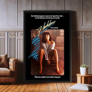 May include: A black and white movie poster for the film Flashdance. The poster features a woman in a white shirt and black shorts, with the title of the film in large, stylized letters. The tagline "What a feeling" is also featured on the poster.