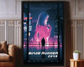 May include: A framed Blade Runner 2049 movie poster featuring a large, glowing pink silhouette of a person standing behind a dark figure in a city landscape. The text reads YOU LOOK LIKE A GOOD JOE, RYAN GOSLING, HARRISON FORD, BLADE RUNNER 2049, DENIS VILLENEUVE.