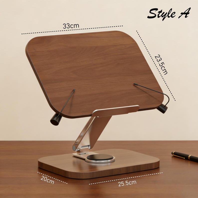 May include: A wooden book stand, Style A, with a rectangular base measuring 25.5cm x 20cm (10 x 7.9 inches). The angled top, 33cm x 23.5cm (13 x 9.3 inches), is supported by a silver-colored metal frame. The stand has black stoppers to hold the book pages.